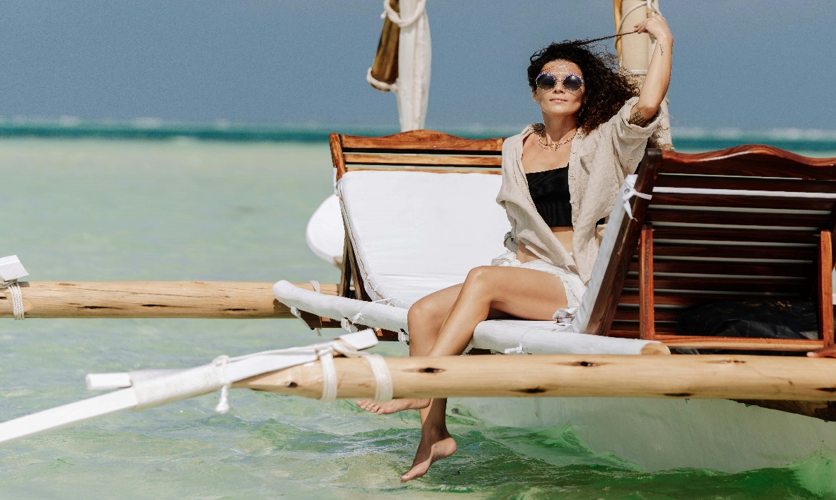 A tourist on a traditional dhow in Zanzibar.
