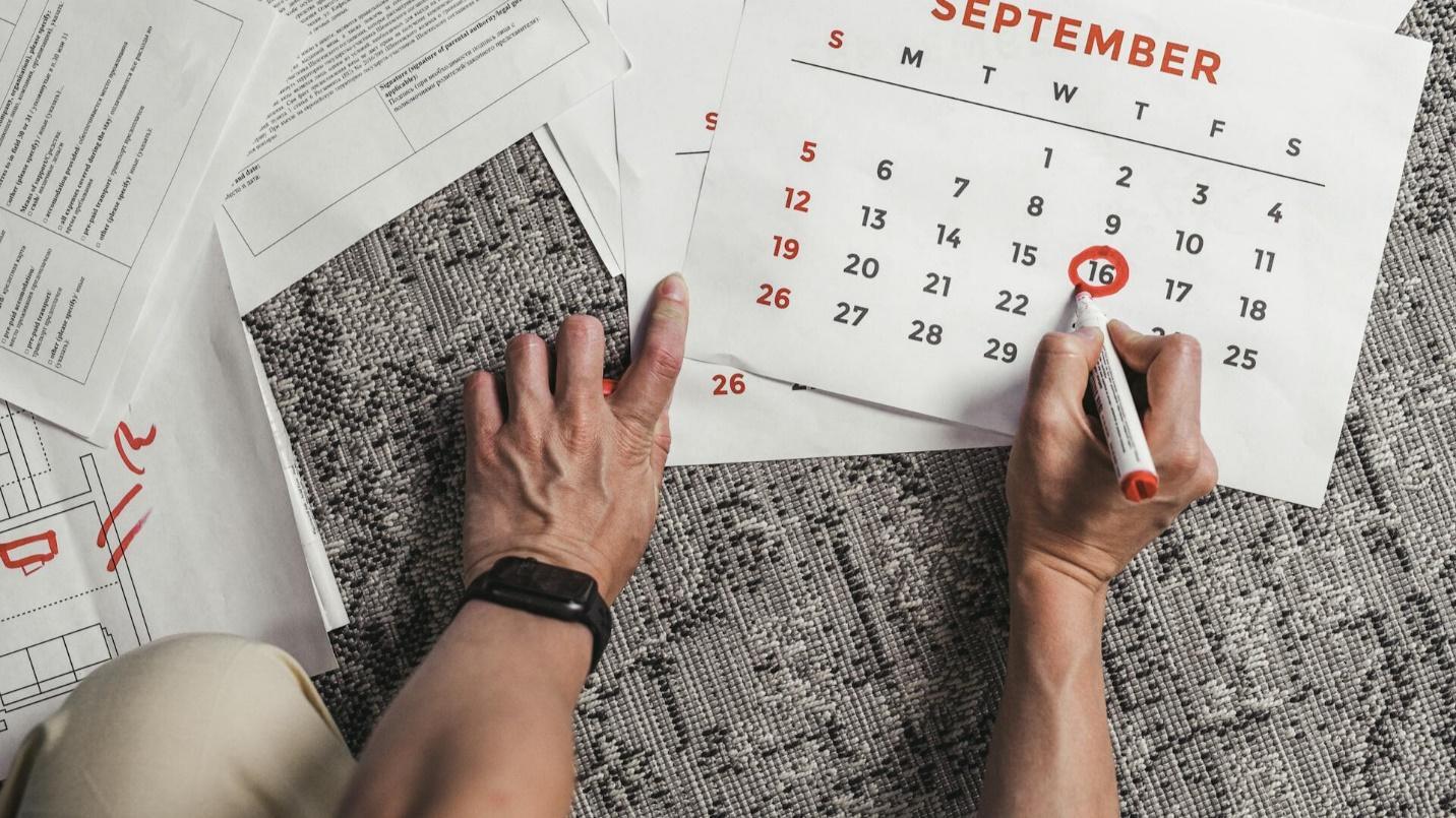 A person marking a date on a calender