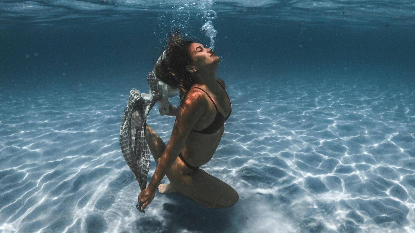 A lady swimming in the ocean
