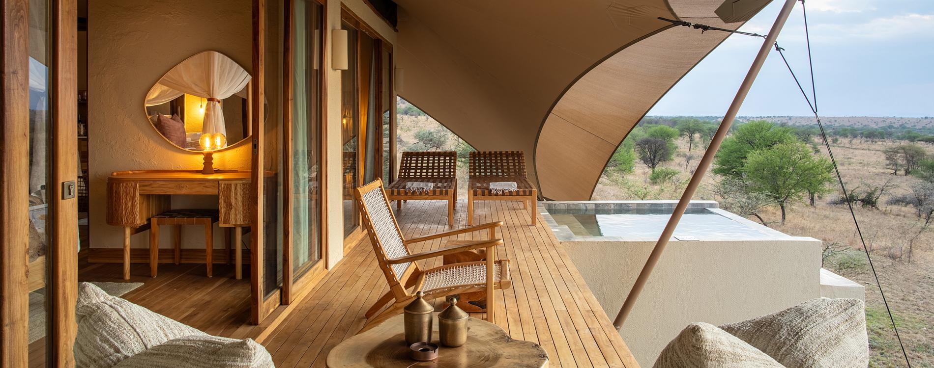 Interior of a luxury safari tent with a view of the wilderness.