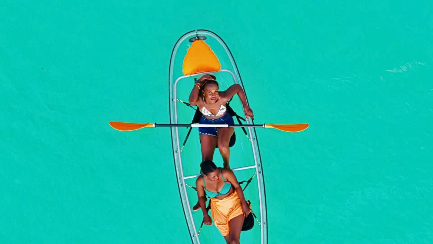 Ladies in a canoe in the ocean