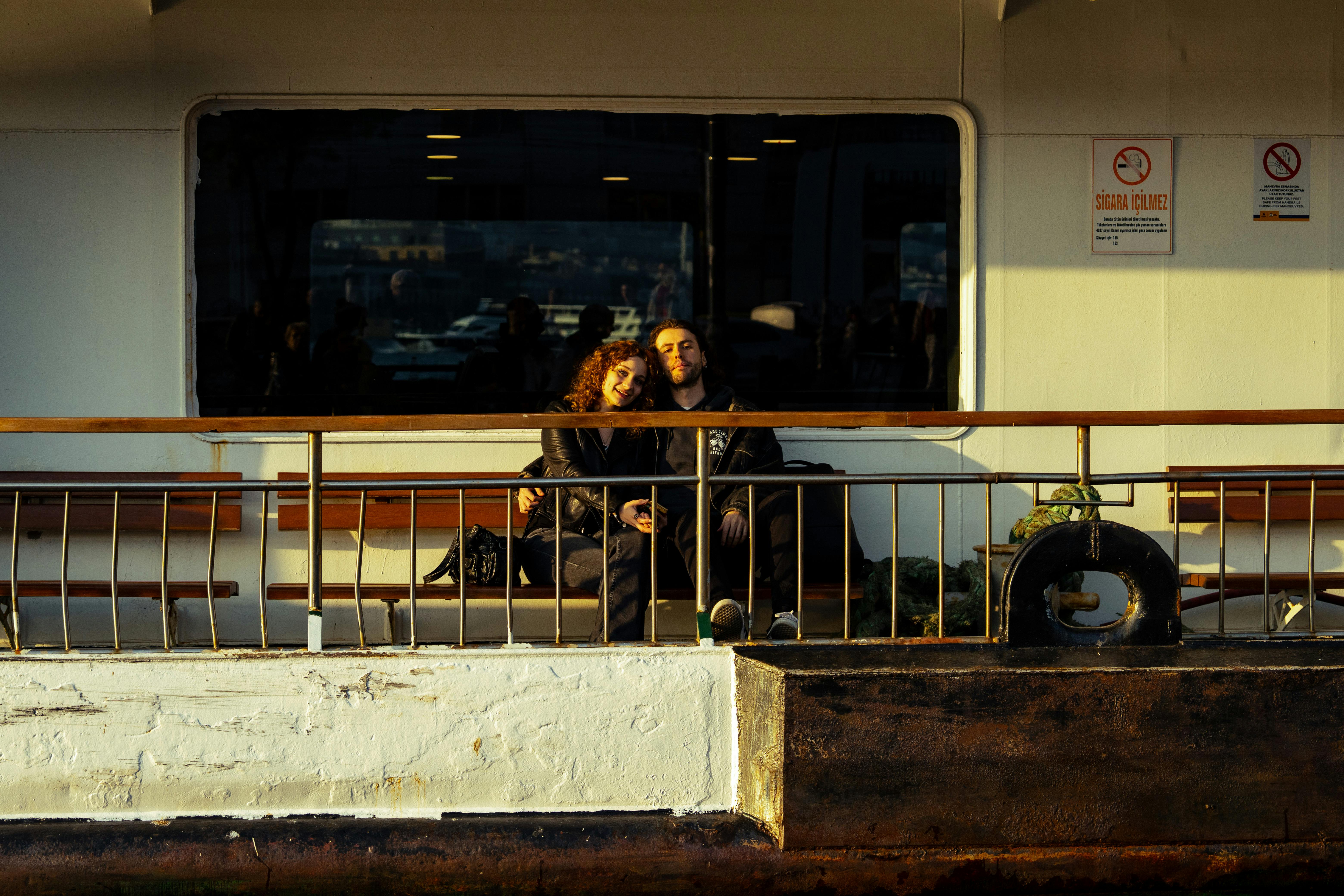 A couple standing on the deck of a ferry